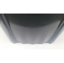 Detailní pohled na černý plastový květináč s vlnitým spodním okrajem.