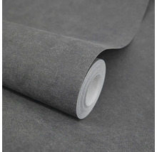 Strukturovaná vliesová tapeta s tmavě šedým vzhledem kamene na roli.