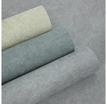 Tři role vliesové tapety se vzhledem betonu a strukturovaným povrchem v béžové, tmavě šedé a světle šedé barvě.