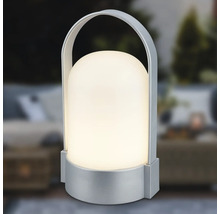 Přenosná stolní LED lampa se stříbrným podstavcem a držadlem, stínidlo ve tvaru kopule, teplé bílé světlo.