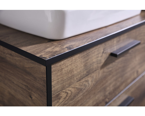 Detailní pohled na skříňku pod umyvadlo s dřevěným vzorem a zásuvkami