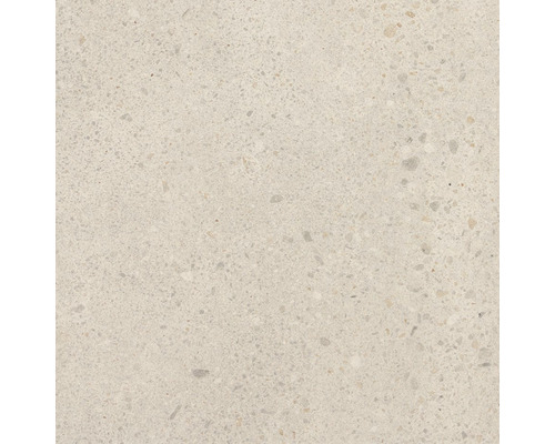 Detail světlé betonové dlaždice se skvrnitou texturou