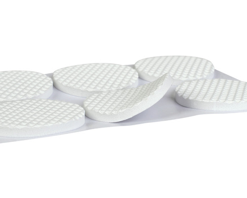 Několik pěnových kluzáků na nábytek na listu