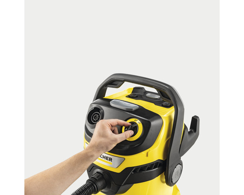 Žlutý čisticí vysavač Kärcher s rukou na otočném knoflíku pro regulaci sacího výkonu.