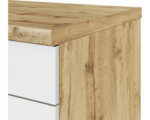 Detail skříně s dřevěným povrchem a bílými zásuvkami