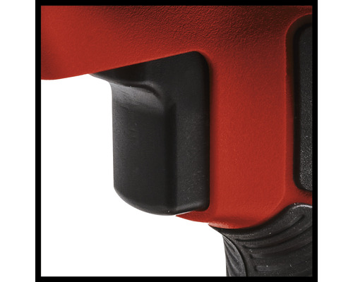 Detail červeného elektrického nářadí s černým spínačem