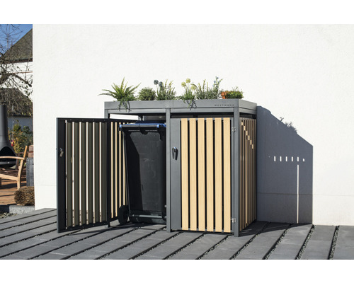 Kontejner na popelnice s rostlinami na střeše a popelnice