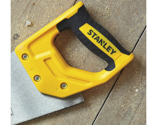 Ruční pila s logem Stanley na dřevěném pozadí