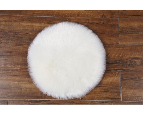 Kulatý koberec z umělé kožešiny na dřevěné podlaze