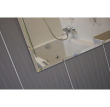 Detail zrcadla na stěně koupelny s obklady