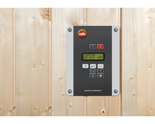 Logo Weka na ovládací jednotce pro saunu na dřevěné stěně