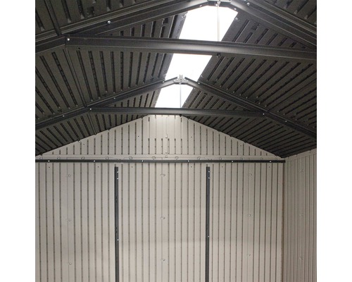 Vnitřní pohled na zahradní domek se střešním oknem a kovovým rámem