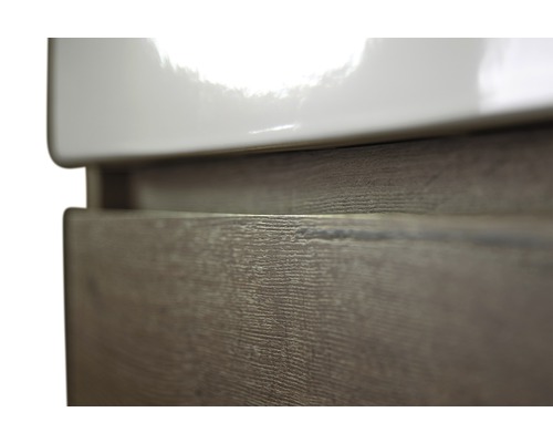 Detailní pohled na skříňku pod umyvadlo s dekorem dřeva a keramickým umyvadlem