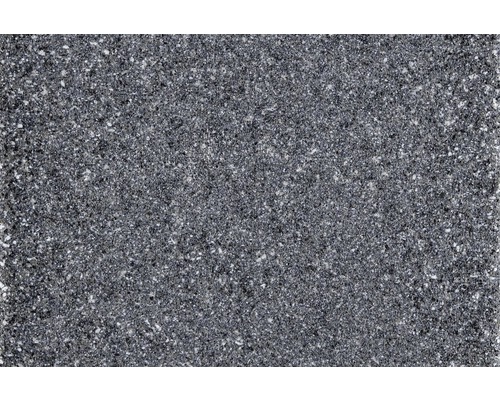 Detailní záběr tmavé pracovní desky s tečkovaným povrchem