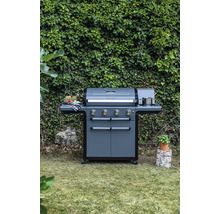 Tmavě šedý plynový gril se čtyřmi hořáky a bočními stolky na zahradě