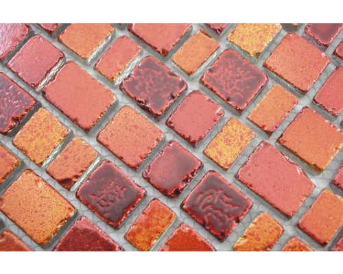 Detailní záběr mozaikových dlaždic v různých odstínech červené