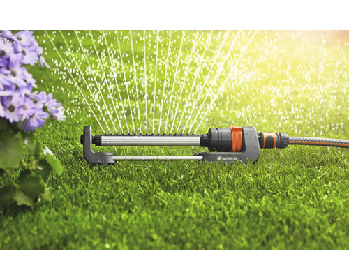 Zavlažovač trávníku zavlažuje trávník v zahradě