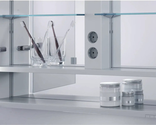 Koupelnová scéna s kelímky na zubní kartáčky, zubními kartáčky, zásuvkami a kosmetickými dózami v zrcadlové skříňce