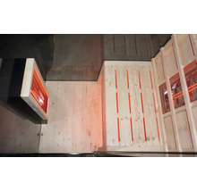 Vnitřní pohled na saunu s dřevěnými stěnami a infračerveným zářičem