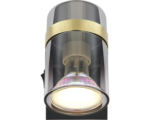 Nástěnné svítidlo s válcovým stínidlem a zapnutou žárovkou.