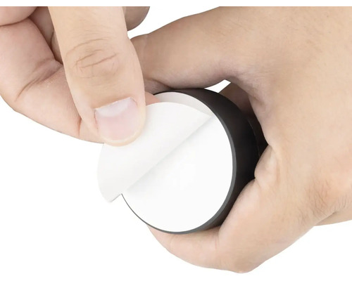 Ruce odstraňují ochrannou fólii z lepicí podložky