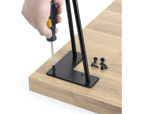 Montáž nohy stolu pomocí šroubováku a šroubů k desce stolu.