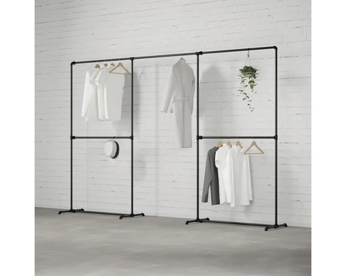 Volně stojící šatní skříň z kovových trubek s oblečením a dekorací