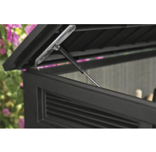 Detailní pohled na otevřené víko úložného boxu s tlumičem