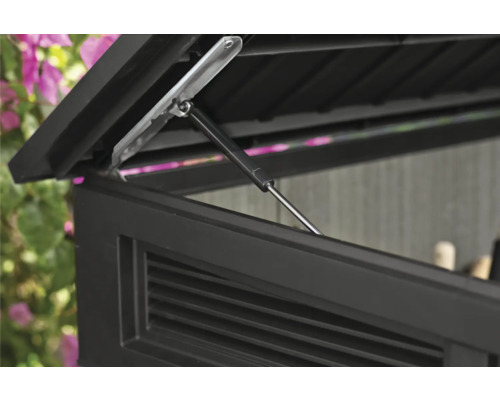 Detailní pohled na otevřené víko úložného boxu s tlumičem