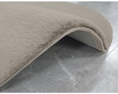 Detailní pohled na béžový koberec s vysokým vlasem