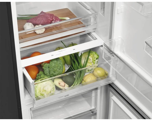 Vnitřní pohled na chladničku s potravinami v zásuvkách a přihrádkách