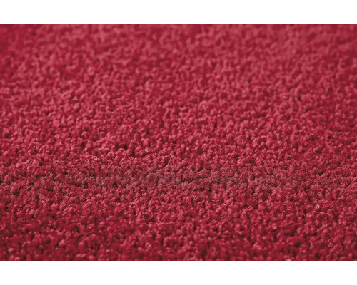 Detail červeného koberce s vysokým vlasem.