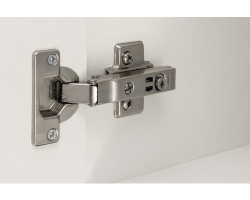 Kovový nábytkový pant na bílém povrchu