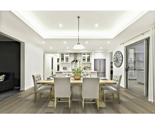 Světlá jídelna s dřevěným stolem, čalouněnými židlemi a otevřenou kuchyní