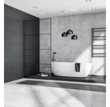 Moderní koupelna s volně stojící vanou, tmavou akcentní stěnou a stylovým osvětlením.