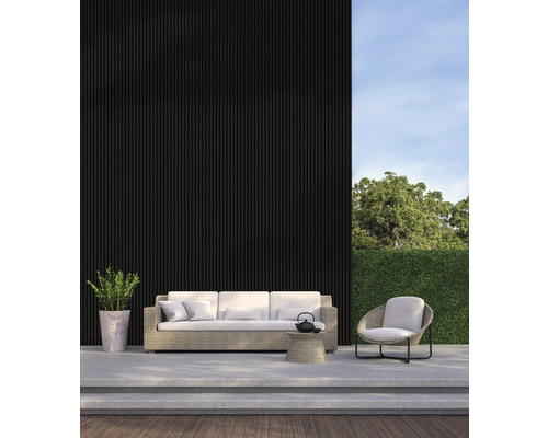 Terasa s posezením skládající se z pohovky, křesla a malého stolku před černou stěnou