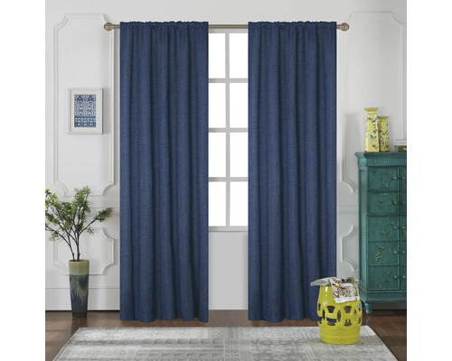 Dva modré závěsy visí před oknem v jasné místnosti.