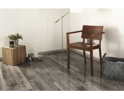 Obývací pokoj s dřevěnou podlahou, dřevěnou židlí, stojací lampou a odkládacím stolkem