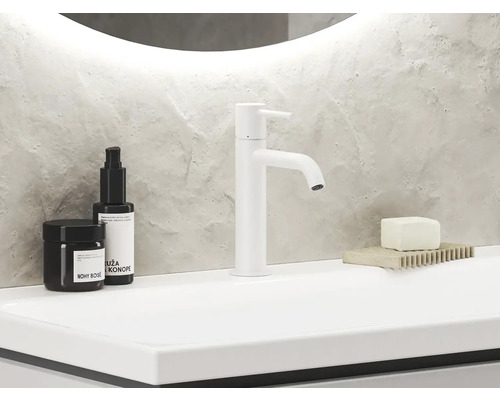 Moderní koupelnové umyvadlo s baterií, mýdlem a přípravky pro péči o pleť