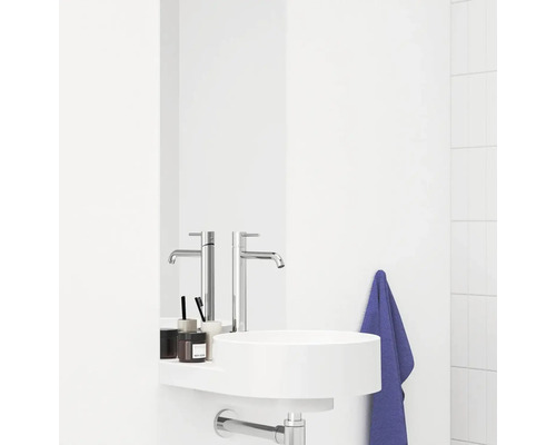 Moderní koupelna s kulatým umyvadlem, baterií a ručníkem