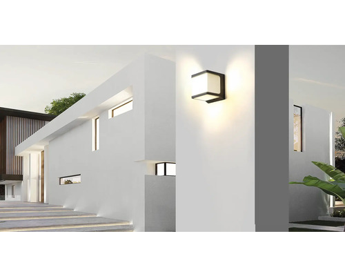 Moderní fasáda domu s osvětleným venkovním nástěnným svítidlem.