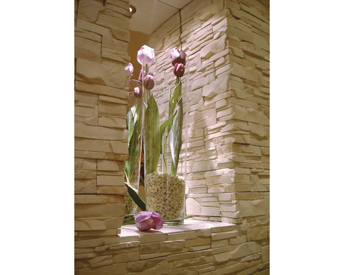 Dekorativní tulipány ve skleněných vázách před kamennou zdí