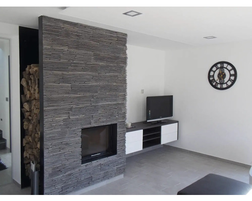 Obývací pokoj s krbem, televizním nábytkem a skladem dřeva