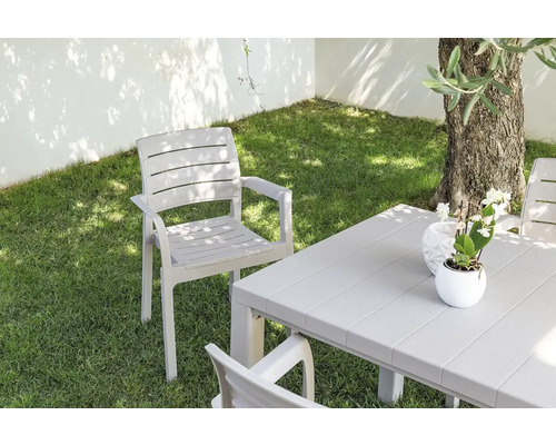 Zahradní scéna se zahradním stolem a zahradními židlemi na trávníku