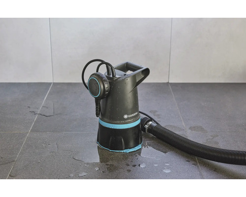 Zahradní čerpadlo s hadicí na dlaždicové podlaze