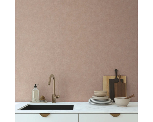 Moderní kuchyňská scéna s dřezem, vodovodní baterií, nádobím a prkénky před texturovanou stěnou