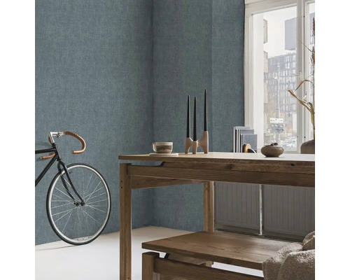 Obývací pokoj se strukturovanými stěnami, dřevěným stolem a jízdním kolem