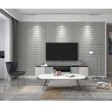 Obývací pokoj se šedým 3D stěnovým panelem, televizí, stolem a židlí