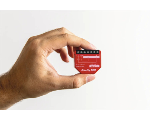 Ruka drží vypínač chytré domácnosti Shelly Gen3.