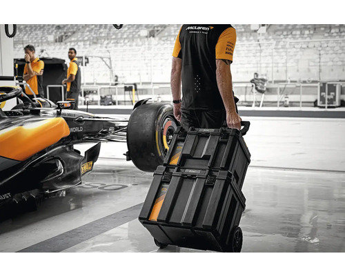 Osoba táhne vozík na nářadí v dílně